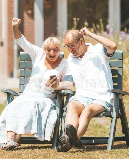 bb6c7916-201e-4737-9082-c5713b2a3db9-happy-senior-retired-couple-love-watching-smartphone-raised-hands-screaming-happy-senior-retired-couple-love-191662680.jpg